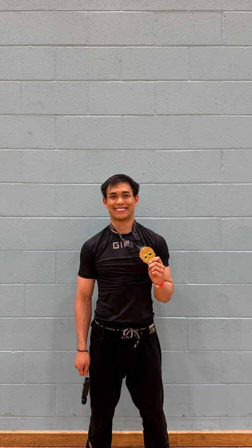 Van holding a gold medal after Grappling Industries London